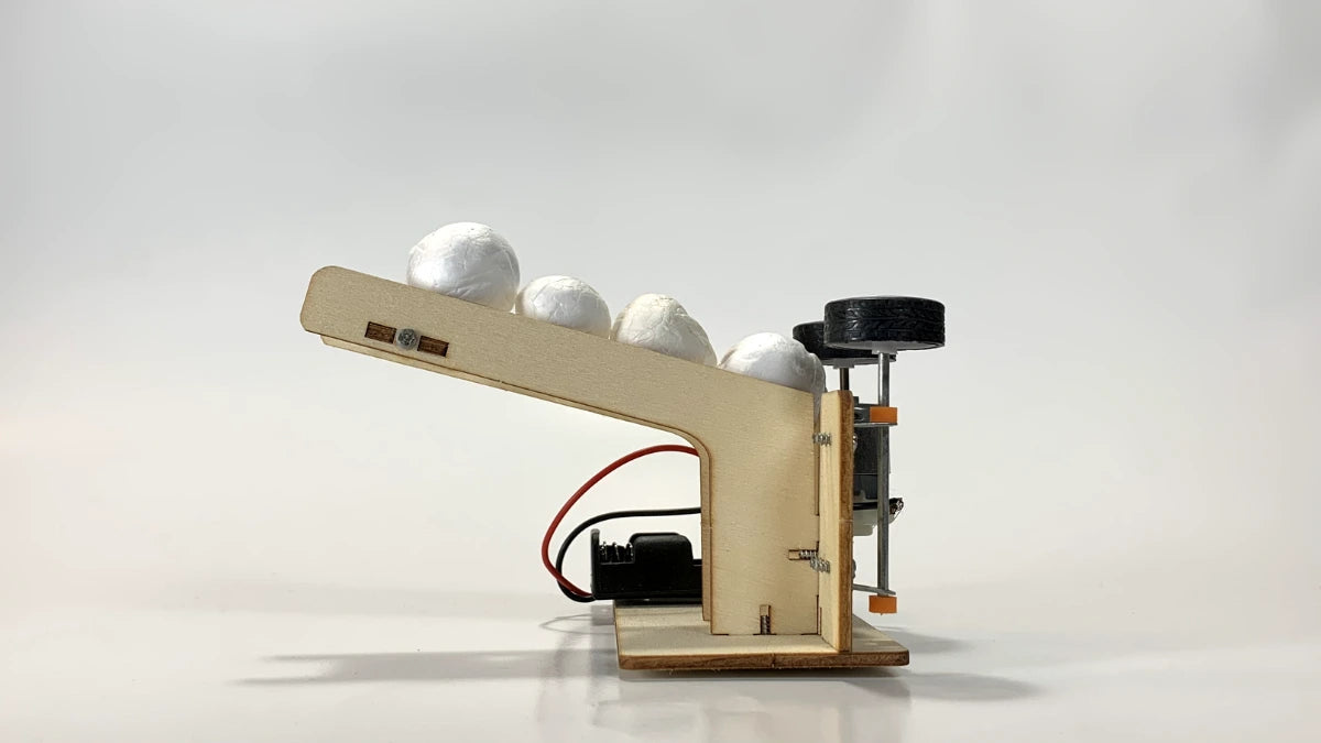 Side View of STEM Ball Pitching Machine Kit – Wooden DIY Model with Motor, Ramp, and Battery Pack for STEM Learning