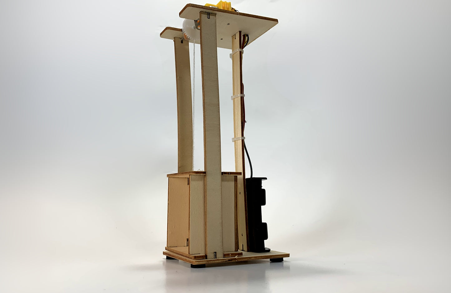 Angled Side View of Electric Elevator STEM Kit – Wooden DIY Model with Battery Pack, Wiring, and Pulley System for STEM Education