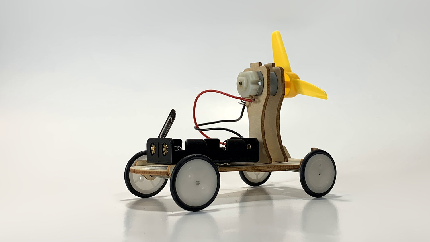 Alternate Side View of Electric Wind Car STEM Kit – Wooden DIY Model with Yellow Propeller, Motor, and Battery Pack for STEM Learning