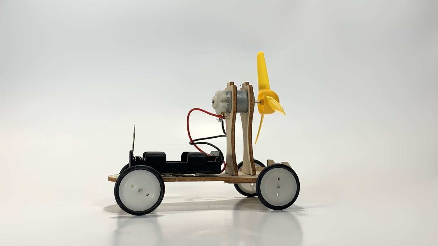 Side Profile View of Electric Wind Car STEM Kit – Wooden DIY Model with Yellow Propeller, Motor, and Battery Pack for STEM Education