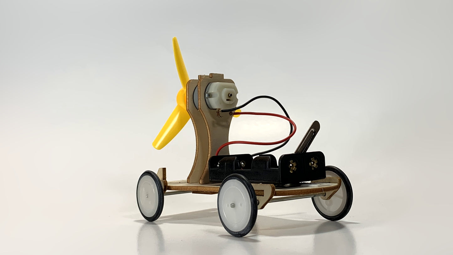 Side View of Electric Wind Car STEM Kit – Wooden DIY Model with Yellow Propeller, Motor, and Battery Pack for STEM Learning