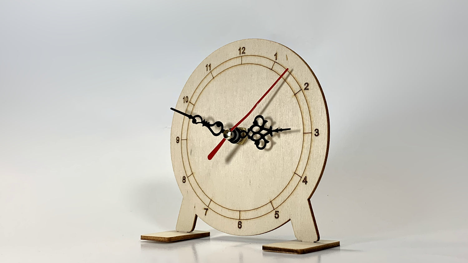 Front view of My Little Clock STEM Kit showing wooden clock face with hour, minute, and second hands