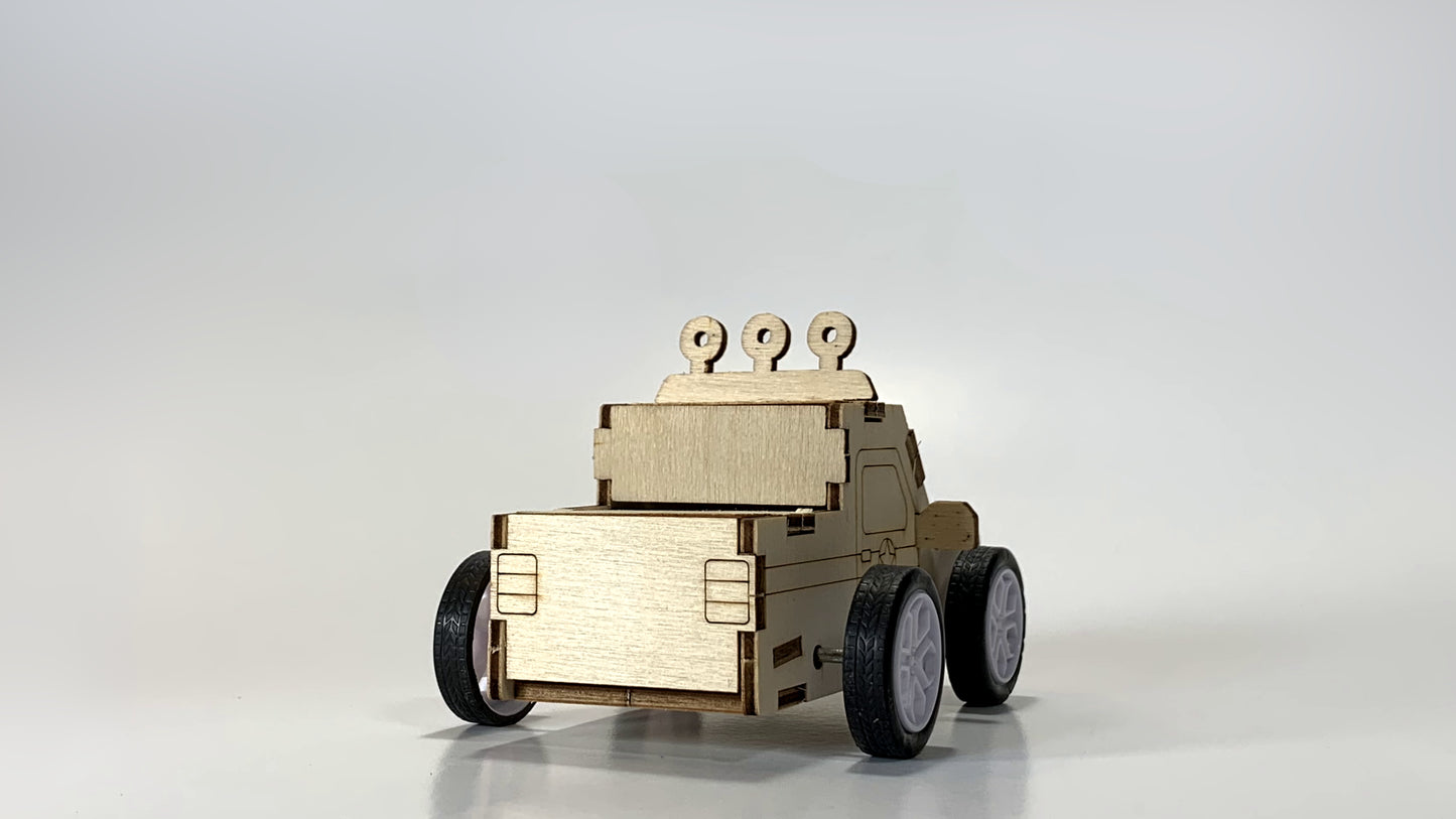 Rear view of the Pull-Back Race Car STEM Kit, showcasing the wooden cargo bed, sturdy wheels, and detailed laser-cut design