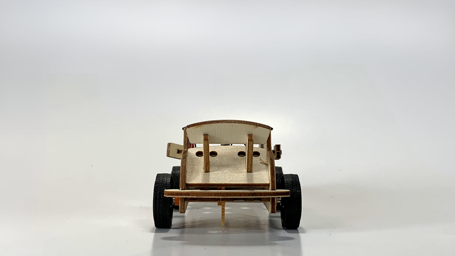 Rear view of the Solar-Powered Race Car STEM Kit, showcasing the wooden spoiler, rear design, and sturdy wheels for stability