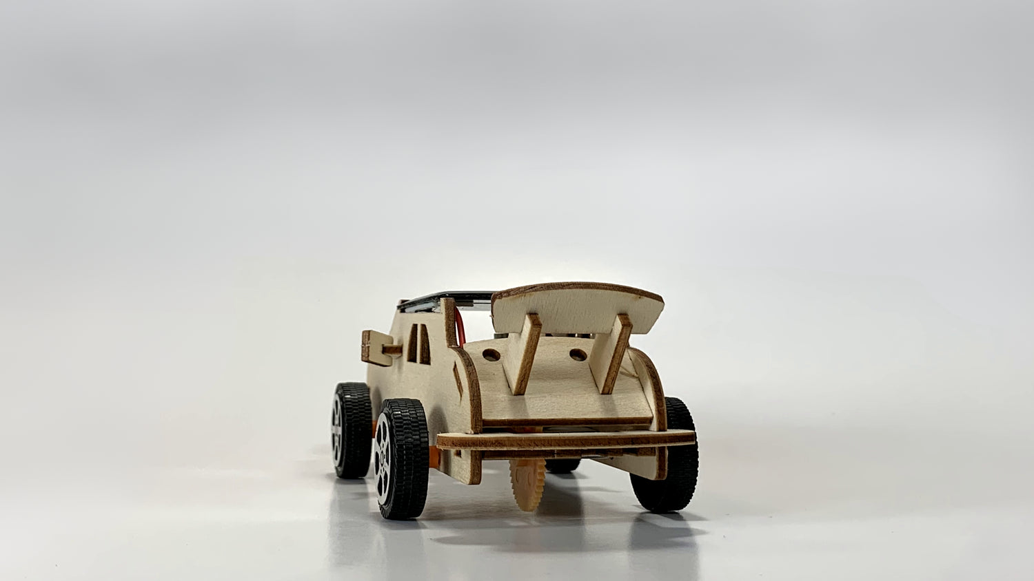 Rear view of the Solar-Powered Race Car STEM Kit, showcasing its wooden spoiler, rear design, and sturdy wheels