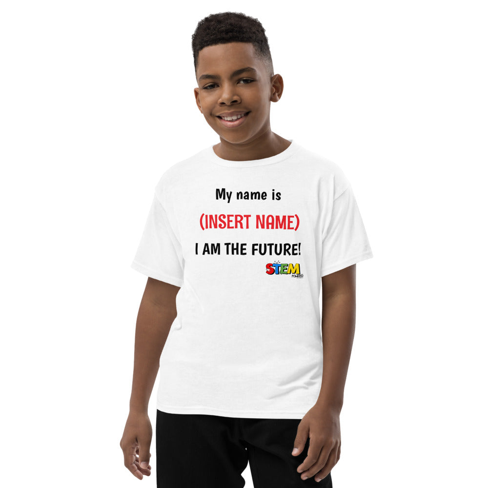 Young boy smiling while modeling a STEM Powered Kits T-shirt featuring customizable text 'My Name is (Insert Name) I Am the Future!' promoting STEM inspiration.